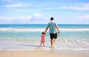 Father on beach with child
