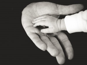 Child holding fathers hand