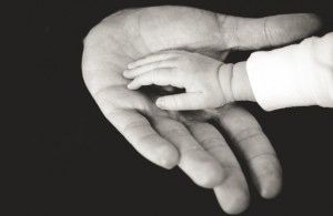 A childs hand in fathers hand