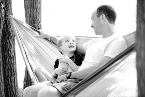 Man and child sitting in a hammock