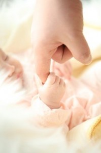 Child holding parents finger